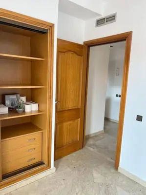 an empty room with a closet and a wooden door at New nice apartment city center swimming pool wifi in Marrakech