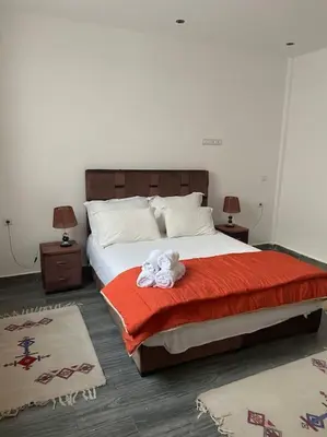 a bedroom with a bed with a stuffed animal on it at Marrakech Dar El Hijazi 2 in Marrakech