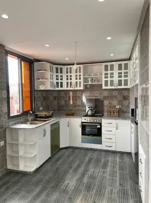 a large kitchen with white cabinets and appliances at Marrakech Dar El Hijazi 2 in Marrakech