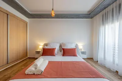 a bedroom with a large white bed with red pillows at Apprtement -74-de luxe haut gamme guéliz in Marrakech