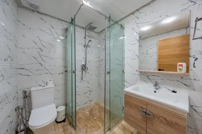 a bathroom with a glass shower and a toilet at Apprtement -74-de luxe haut gamme guéliz in Marrakech