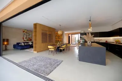a kitchen and living room with a table and a dining room at Villa zen in Marrakech