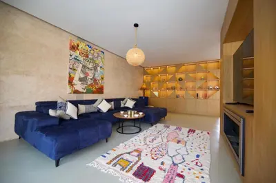 a living room with a blue couch and a table at Villa zen in Marrakech
