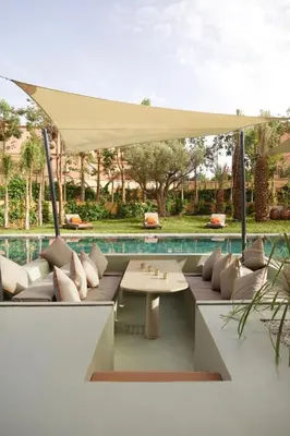 a patio with a white umbrella and a table at Villa zen in Marrakech