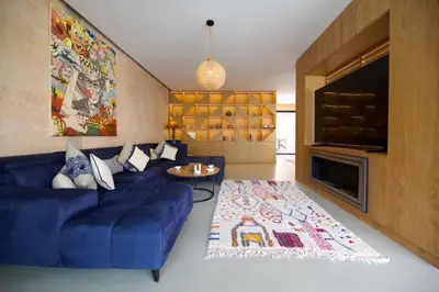 a living room with a blue couch and a rug at Villa zen in Marrakech