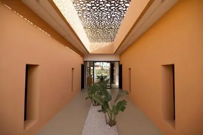 a hallway with orange walls and a skylight at Villa zen in Marrakech