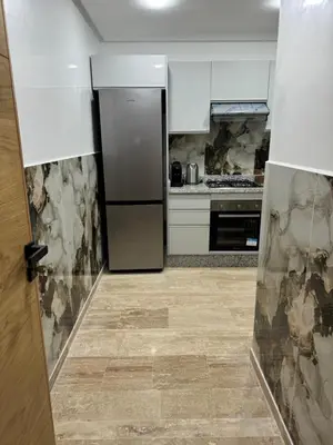 a kitchen with a stainless steel refrigerator in it at Luxueuse Apparemment -143 haut standing in Marrakech