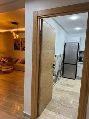 a sliding door in a room with a living room at Luxueuse Apparemment -143 haut standing in Marrakech