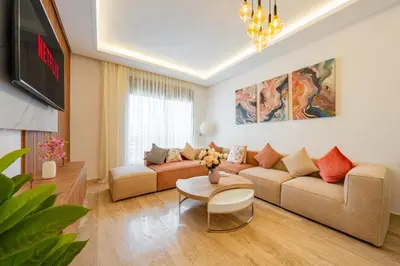 a living room with a couch and a table at Luxueuse Apparemment -143 haut standing in Marrakech