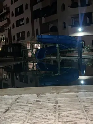 a swimming pool with blue inflatables in a building at Premuim village Marrakech in Marrakech