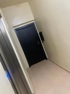 a black door in a room with a tile floor at Premuim village Marrakech in Marrakech