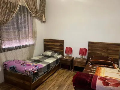 a bedroom with two beds and a window at Premuim village Marrakech in Marrakech