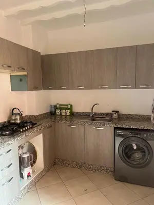 a kitchen with a washer and a washing machine at Premuim village Marrakech in Marrakech