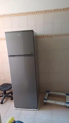 a kitchen with a refrigerator in a room at الأزهار in Marrakech