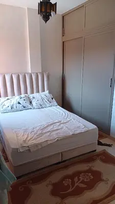 a bedroom with a bed and a closet at الأزهار in Marrakech