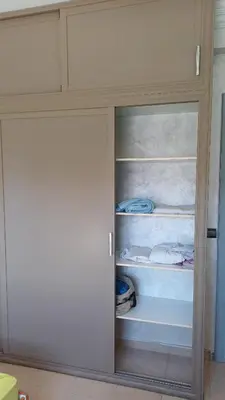 a cupboard with a door open to a room at الأزهار in Marrakech