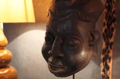 a statue of a head on a wall next to a lamp at Riad MONDRIAH in exclusivity only for you in Marrakech