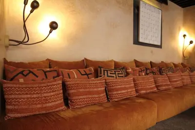 a brown couch with pillows on it in a room at Riad MONDRIAH in exclusivity only for you in Marrakech