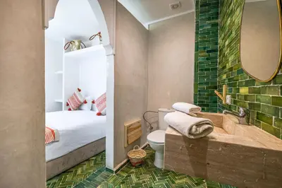 a bathroom with a tub and a bedroom with a bed at Riad Symba Exclusive with New Heated Pool and Breakfast Included in Marrakech