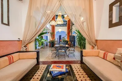 a living room with two couches and a table at Riad 5 sens in Marrakech