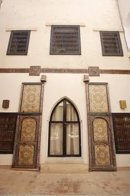 a building with two doors and a window at Riad 5 sens in Marrakech
