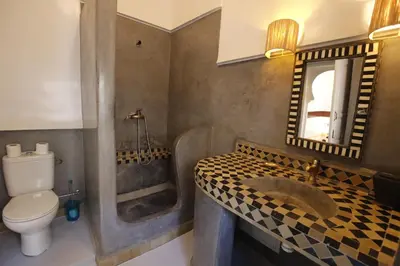 a bathroom with a sink and a toilet and a shower at Riad 5 sens in Marrakech