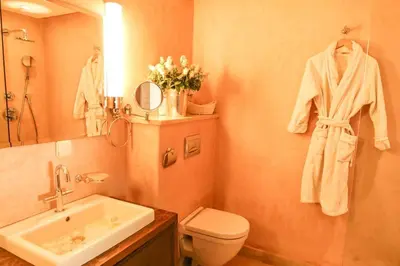 a bathroom with a sink and a toilet and a mirror at Villa Angel 42 Al Maaden Golf Resort in Marrakech