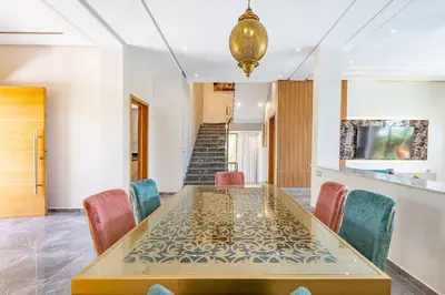 a dining room with a table and chairs at Villa Narjisse , Élégance et Calme, piscine privée in Marrakech