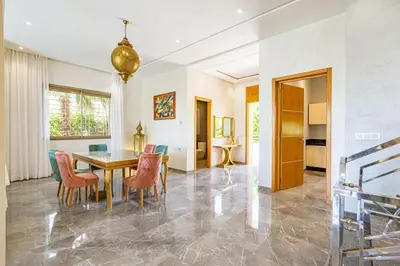 a dining room with a table and chairs at Villa Narjisse , Élégance et Calme, piscine privée in Marrakech