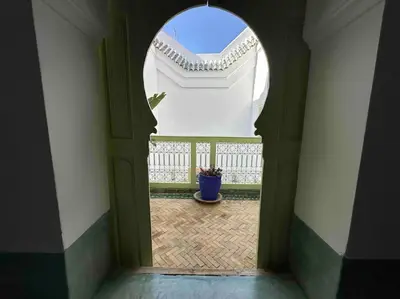 an archway in a building with a potted plant at Dar Hatim in Marrakech