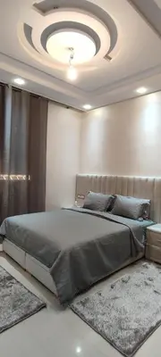 a bedroom with a large bed with a ceiling at مراكش تاركة in Marrakech