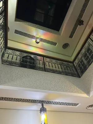 a ceiling with a mirror and a light on it at Riad Ramadan House Marrakech in Marrakech