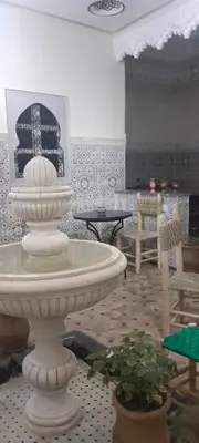 a room with a large white fountain in a room at Riad Ramadan House Marrakech in Marrakech