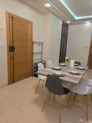 a dining room with a table and white chairs at Marrakech-Central location 2 Bdrm in Marrakech