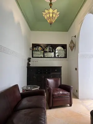 a living room with a couch and a chair at Riad Panthera, Médina in Marrakech
