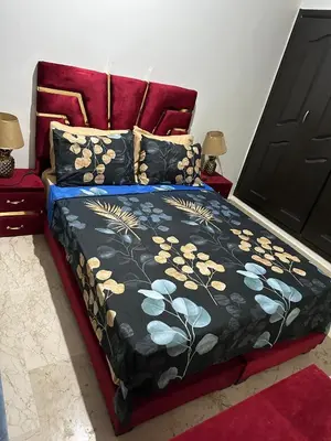 a bedroom with a bed with a red headboard at appartement 9 simple et fonctionnel pour famille in Marrakech
