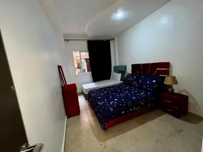 a small bedroom with a bed and a window at appartement 9 simple et fonctionnel pour famille in Marrakech