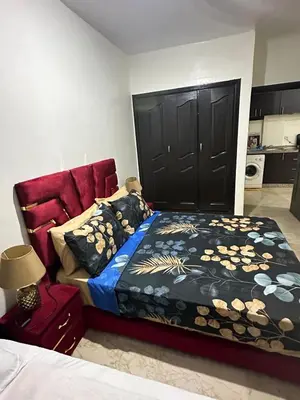a bedroom with a bed and a black door at appartement 9 simple et fonctionnel pour famille in Marrakech