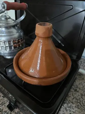 a wooden object sitting on top of a stove at appartement 9 simple et fonctionnel pour famille in Marrakech