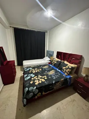 a bedroom with a bed and a couch in it at appartement 9 simple et fonctionnel pour famille in Marrakech