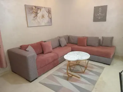 a living room with a couch and a table at Luxury Apartment With Swiming Pool in Hivernage Marrakech in Marrakech