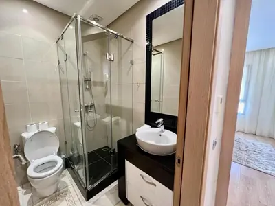 a bathroom with a shower and a toilet and a sink at Prestigia Apart 29 in Marrakech