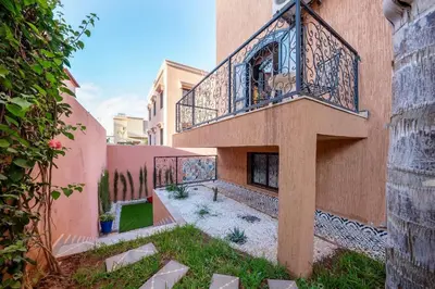 a building with a balcony on the side of it at Beautiful Central Marrakech Villa in Marrakech