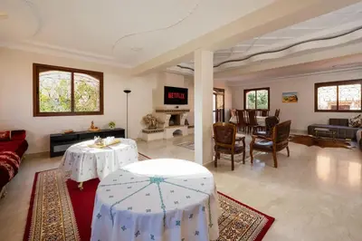 a living room with two tables and a couch at Beautiful Central Marrakech Villa in Marrakech