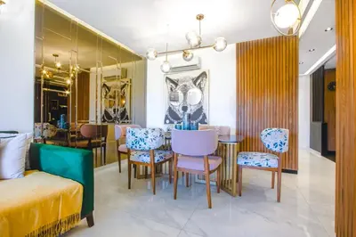 a dining room with a table and chairs at Appartement prestigia Jad in Marrakech
