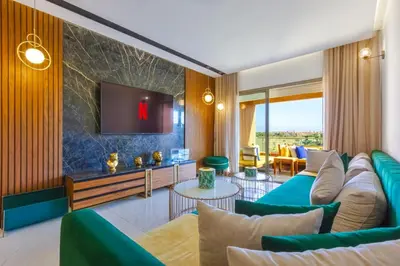 a living room with a couch and a tv at Appartement prestigia Jad in Marrakech
