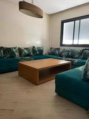 a living room with a couch and a coffee table at شقق جيليز in Marrakech