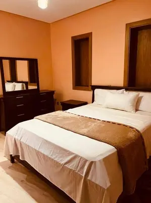 a bedroom with a large bed and a mirror at شقق جيليز in Marrakech