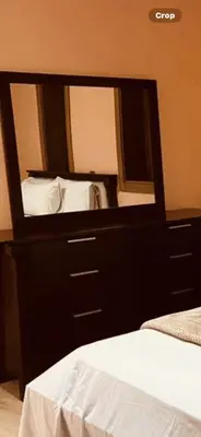 a bedroom with a large mirror above a bed at شقق جيليز in Marrakech