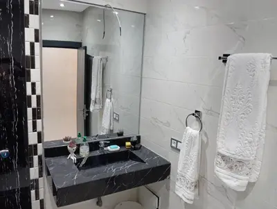 a bathroom with a black sink and a mirror at Marrakech -giliz in Marrakech